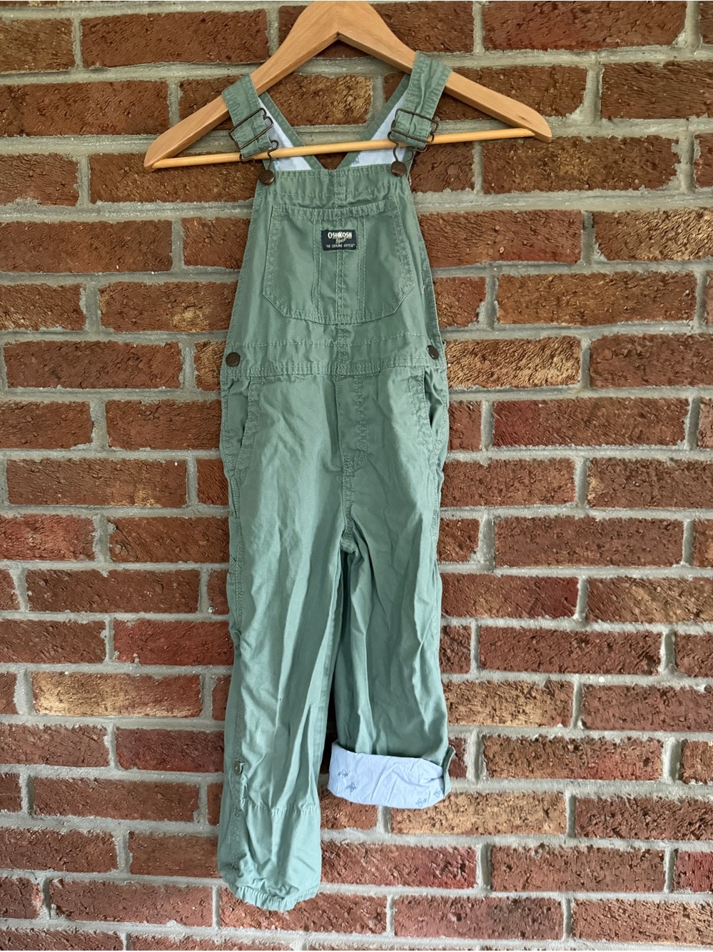 OshKosh B'gosh Kids Green Overalls. Airplanes on inside. 5T size.